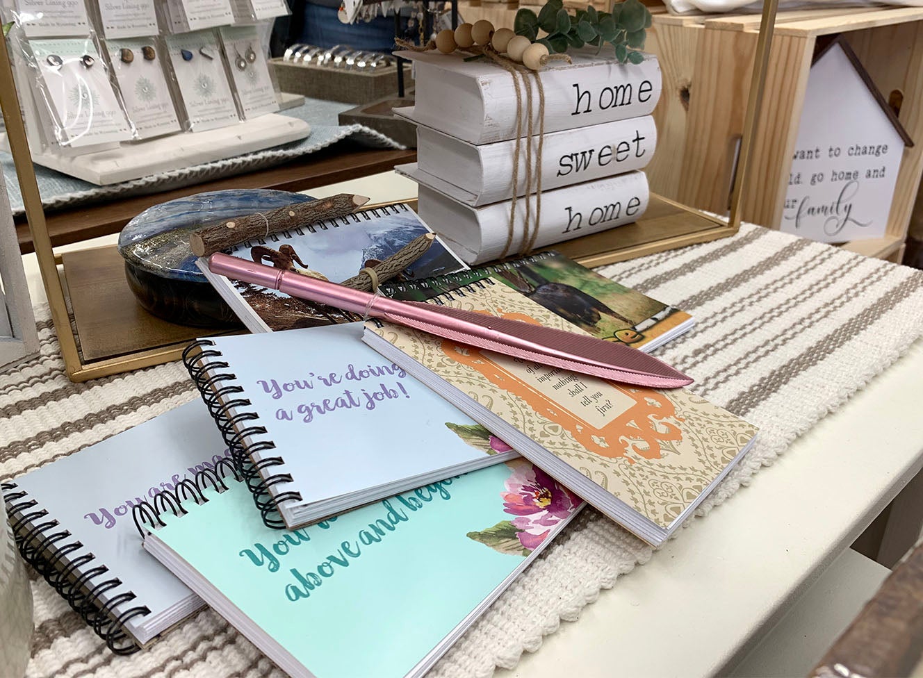 We have notebooks, greeting cards, calendars, journals, and even pens for sale.